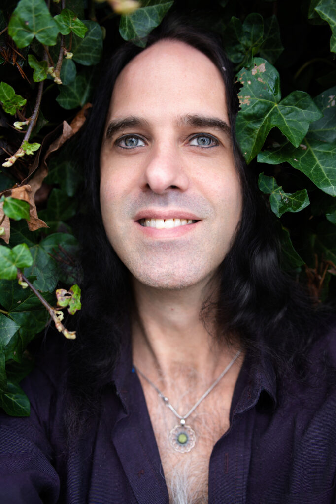 Smiling man lying in ivy